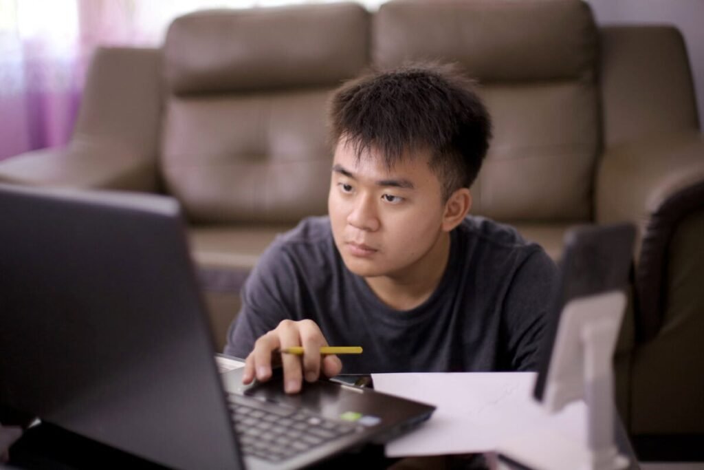 Young adult concentrates on laptop screen